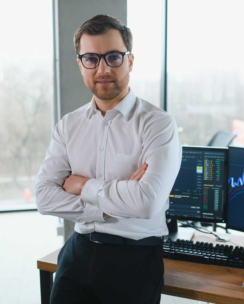 man-trader-in-formalwear-sitting-at-desk-in-frot-o-2023-11-29-23-56-00-utc.jpg
